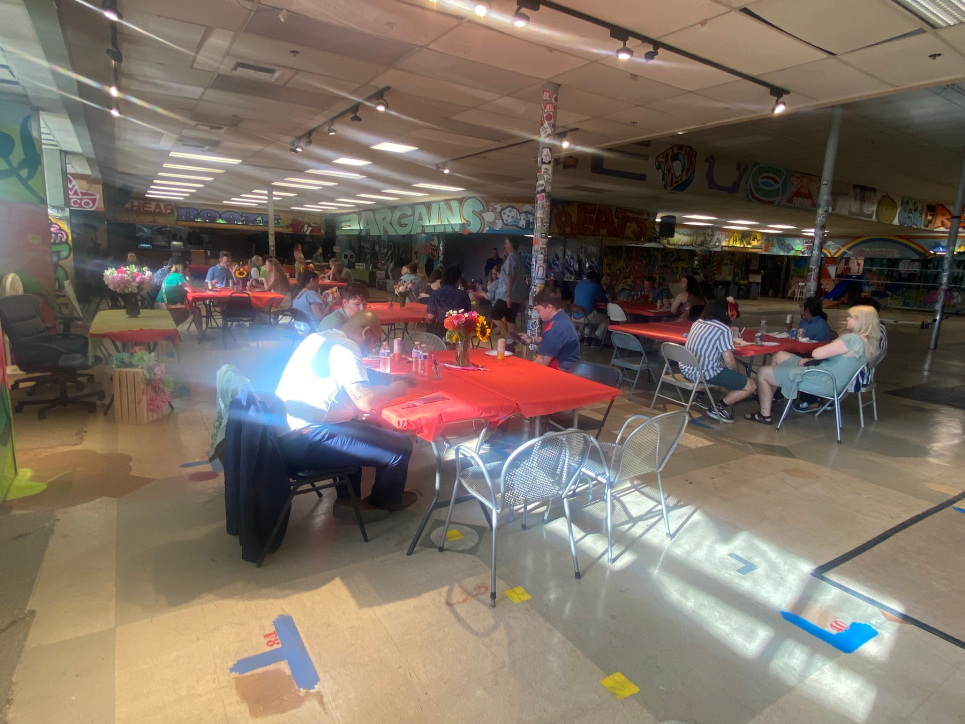 Banquet tables set on the old supermarket floor for a private event