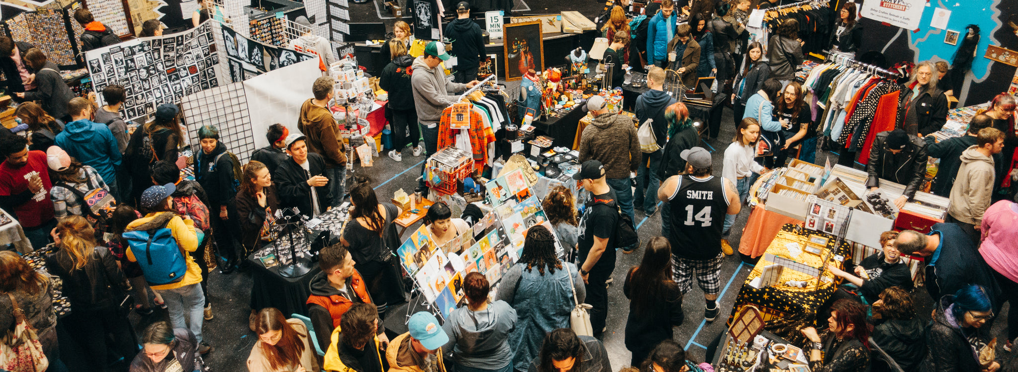 Overhead view of a packed Punk Rock Flea Market hall full of vendor booths and shoppers